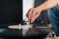 Close-up hands of unrecognizable young man adjusting head old record player and vinyl discs. Music lover male listening Royalty Free Stock Photo