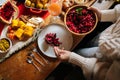 Close-up hands of unrecognizable young woman putting salad on plate preparing Christmas table at home for family party Royalty Free Stock Photo