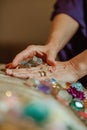 Close-up of hands using crystal therapy on a client