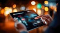 Close-up of hands using a digital tablet in a warm glowing environment Royalty Free Stock Photo