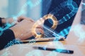 Close up of hands using laptop with creative glowing blockchain hologram on blurry desktop background. Cryptocurrency and