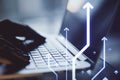 Close up of hands using laptop with glowing digital arrows on blurry office desktop background. Technology, big data and Royalty Free Stock Photo