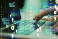 Close up of hands using laptop keyboard with abstract coding binary code hologram on blurry background. Artificial intelligence Royalty Free Stock Photo