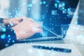 Close up of hands using laptop keyboard with creative binary coding hologram on blurry background. Software programming code. Royalty Free Stock Photo