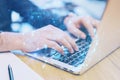 Close up of hands using laptop keyboard on office desktop with creative digital linear sphere on blurry background. Global network
