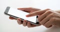 Close up of hands using a modern smartphone touching the blank screen for app navigation Royalty Free Stock Photo