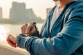 Close up hands using smart watch to monitor performance. Sport woman is setting up her smart watch before run Royalty Free Stock Photo