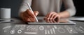 Close Up of Hands Using Tablet and Stylus on Clean Desk Surface with Creative Drawings Royalty Free Stock Photo
