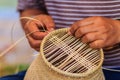 Close up hands weaving bamboo steamer in northeastern village of