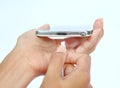 Close-up hands of woman connects plug of charger mobile phone or smartphone charging on white background