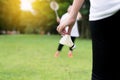 Close up of hands woman holding badminton racket and shuttlecock in public park Royalty Free Stock Photo