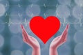 Close up Hands woman Holding and save Heart donor Icon Isolated On wave ekg and blurry background