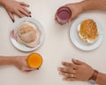 Close up of couple eating healthy sandwiches and fruit juices