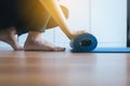 Close up of hand woman rolling or folding blue yoga mat after a workout,Exercise equipment