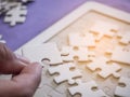 Close-up of hands woman`s holding connecting jigsaw puzzle with sunlight effect. Space for text Royalty Free Stock Photo