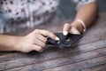 Close up of hands woman using her cell phone. Outdoor.