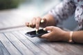 Close up of hands woman using her cell phone. Outdoor. Royalty Free Stock Photo