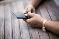 Close up of hands woman using her cell phone. Outdoor. Royalty Free Stock Photo