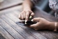 Close up of hands woman using her cell phone. Outdoor. Royalty Free Stock Photo