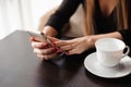 Close up of hands woman using her cell phone in restaurant Royalty Free Stock Photo