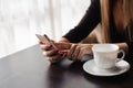 Close up of hands woman using her cell phone in restaurant Royalty Free Stock Photo