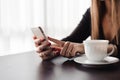 Close up of hands woman using her cell phone in restaurant, cafe. Royalty Free Stock Photo