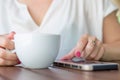 Close up of hands woman using her cell phone in restaurant Royalty Free Stock Photo