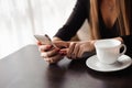 Close up of hands woman using her cell phone in restaurant, cafe. Royalty Free Stock Photo