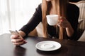 Close up of hands woman using her cell phone in restaurant, cafe. Royalty Free Stock Photo