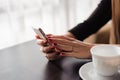 Close up of hands woman using her cell phone in restaurant, cafe Royalty Free Stock Photo