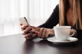 Close up of hands woman using her cell phone in restaurant Royalty Free Stock Photo