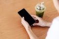 Close up hands of woman using mobile phone, cell phone in coffee shop. Hands of women holding blank empty screen smart phone in Royalty Free Stock Photo