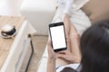 Close up hands of woman using mobile phone, cell phone in coffee shop. Hands of women holding blank empty screen smart phone in Royalty Free Stock Photo