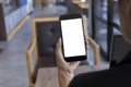 Close up hands of woman using mobile phone, cell phone in coffee shop. Hands of women holding blank empty screen smart phone in Royalty Free Stock Photo