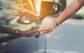 Close up hands woman using systems key near car Royalty Free Stock Photo