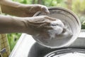 Close up hands of woman washing dishes. Royalty Free Stock Photo