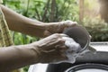 Close up hands of woman washing dishes. Royalty Free Stock Photo