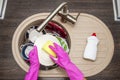 Close up hands of woman washing dishes in kitchen. Hands in red rubber gloves washing the dishes. Top view Royalty Free Stock Photo