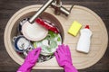 Close up hands of woman washing dishes in kitchen. Hands in red rubber gloves washing the dishes. Top view Royalty Free Stock Photo