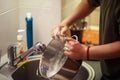 Close up hands of woman washing dishes in the kitchen Royalty Free Stock Photo