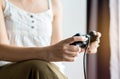 Close up of hands women playing video games at home,Female holding joystick