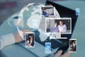 Close up of hands at workplace with devices and creative globe map with computer screens and creative video conference call Royalty Free Stock Photo