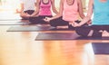 Close up hands of yoga group seated doing Hand Mudra and meditates in a training studio fitness room, Calm and relax