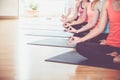 Close up hands of yoga group seated doing Hand Mudra and meditates in a training studio fitness room, Calm and relax