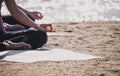 Close up hands of yoga master seated doing Hand Mudra and meditates on beach at coastline, Calm and relax concept,wellness and he