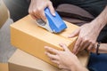 Close up hands, Young asian man and woman taping up a cardboard box