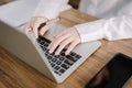 Close-up of the hands of a young businessman working on a keyboard, using computers to study the vast social network Royalty Free Stock Photo