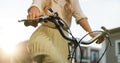 Close up hands of a young girl on vintage bicycle in park.