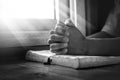 Close up hands of young man praying and reading holy bible, christian black white concept Royalty Free Stock Photo