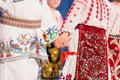 Close up of hands of young Romanian dancers perform a folk dance in traditional folkloric costume. Folklore of Romania Royalty Free Stock Photo
